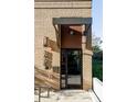 Modern brick building entrance with a metal awning, displaying the address and featuring a secure entry system at 3420 W 32Nd Ave # 203, Denver, CO 80211