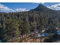 Aerial lot view showing location in wooded mountain area at 5925 Herzman Dr, Evergreen, CO 80439