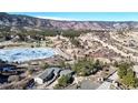 An aerial view of a home nestled within a lakeside mountain community at 6301 Perry Park Blvd # 22, Larkspur, CO 80118