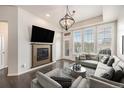 Inviting living room with a fireplace, mounted television, and lots of natural light at 7865 Vallagio Ln # 308, Englewood, CO 80112