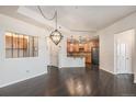 Open concept living room with wood floors with an ornamental divider to the kitchen at 7865 Vallagio Ln # 308, Englewood, CO 80112