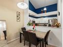 Cozy dining area with a table set for four, adjacent to the kitchen with a stylish accent wall at 5800 Tower Rd # 610, Denver, CO 80249