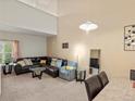 Bright living room with vaulted ceilings, a comfortable sectional, and stylish decor at 5800 Tower Rd # 610, Denver, CO 80249