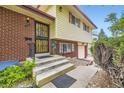 Inviting front entrance with a decorative security door and brick facade details at 1462 S Dudley St, Lakewood, CO 80232