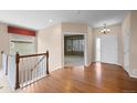 Welcoming foyer with gleaming hardwood floors, a stairway, and abundant natural light creating a warm and inviting atmosphere at 21780 E Heritage Pkwy, Aurora, CO 80016