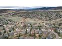 Expansive aerial view of the neighborhood showcasing the mountain views and surroundings at 49 Dawn Heath Cir, Littleton, CO 80127