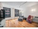 Bright living room with hardwood floors and large windows, offering city views at 444 17Th St # 304, Denver, CO 80202