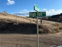 Street sign marks the corner of Bellevue and High Toll Trail in a scenic mountain area at 5826 High Toll Trl, Morrison, CO 80465