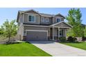 Charming two-story house with an attached garage and a well-manicured front lawn at 11158 Carbondale St, Firestone, CO 80504