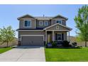 Beautiful two-story home featuring a well-maintained lawn and attached two car garage at 11158 Carbondale St, Firestone, CO 80504