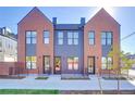 Charming brick townhouse exterior with modern black accents, stylish curb appeal, and well-manicured landscaping at 5148 W 44Th Ave, Denver, CO 80212