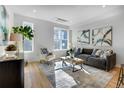Bright living room with large windows, stylish decor, and comfortable seating, perfect for relaxation and entertaining at 5148 W 44Th Ave, Denver, CO 80212