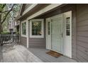 Cozy porch featuring a white door, gray decking, and windows that invite natural light into the home at 6780 W 84Th Cir # 66, Arvada, CO 80003
