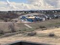 Picturesque view of a new home community against a backdrop of rolling hills and distant snow-capped mountains at 4225 Ridgewalk Pt, Castle Rock, CO 80108