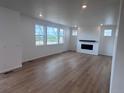 Spacious living room features a fireplace, large windows, and hardwood floors at 4225 Ridgewalk Pt, Castle Rock, CO 80108