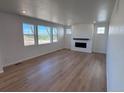 Bright living room with large windows providing plenty of natural light and a modern fireplace at 4225 Ridgewalk Pt, Castle Rock, CO 80108