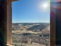 Bright view of rolling terrain from a framed window opening shows the land and homes beyond at 4225 Ridgewalk Pt, Castle Rock, CO 80108