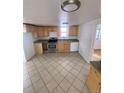 Bright kitchen with wood cabinets and tiled floor at 926 Perry St, Denver, CO 80204