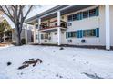 Condo building exterior showcasing a snow covered lawn and building facade at 4980 E Donald Ave # 14, Denver, CO 80222