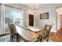 Elegant dining room with hardwood floors, ample natural light, and modern accents at 737 Novick Ct, Castle Rock, CO 80109