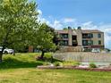 Well maintained condo building with mature landscaping and convenient parking on a sunny day at 539 Wright St # 203, Lakewood, CO 80228