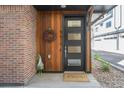 Charming front entrance with a modern door, stylish wreath, and 'Welcome' mat at 5610 S Sycamore St, Littleton, CO 80120