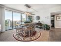 Bright dining area boasts city views, table for six, and stylish modern lighting at 1020 15Th St # 42C, Denver, CO 80202