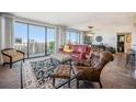 Bright living room featuring a red leather sofa and city views at 1020 15Th St # 42C, Denver, CO 80202