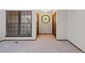 Bright living room with new carpet, large window and unique stained-glass window at 141 S Fraser Cir, Aurora, CO 80012