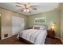 Cozy bedroom with natural light, a ceiling fan, and closet for storage at 8701 Majestic View Dr, Conifer, CO 80433