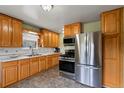 Well-lit kitchen features stainless steel appliances, ample cabinetry, and functional layout for easy meal preparation at 8701 Majestic View Dr, Conifer, CO 80433