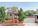 Charming home with a well-maintained front yard, landscaped garden, and inviting entryway at 1025 E Iowa Ave, Denver, CO 80210