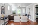 Bright living room with hardwood floors and modern décor that creates a welcoming ambiance at 1025 E Iowa Ave, Denver, CO 80210