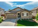 Charming single-Gathering home with a well-manicured lawn, stone accents, and a two-car attached garage at 14116 Double Dutch Cir, Parker, CO 80134