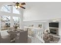 Dining room with a high ceiling, large windows and a view to the fireplace at 9057 Bermuda Run Cir, Highlands Ranch, CO 80130