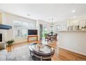 Open-concept living space with hardwood floors, plenty of light, a dining area and kitchen at 8520 S Holland Ln # 102, Littleton, CO 80128