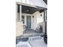 Charming front porch with seating area and modern gray door at 10270 E 62Nd Pl, Denver, CO 80238