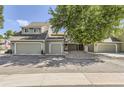 Two-story townhome featuring a two-car garage, easy-to-maintain landscaping, and classic exterior design at 10685 W Apishapa Pass, Littleton, CO 80127