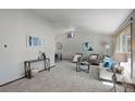 Bright and airy living room featuring neutral colors, plush carpeting, and large windows at 7877 W 110Th Dr, Westminster, CO 80021