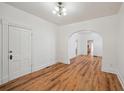 Bright living room featuring wood floors, arched doorways, and fresh white paint at 253 N Lincoln St, Denver, CO 80203
