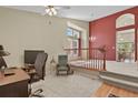 Cozy loft space with plush carpeting, neutral walls, and a lovely view overlooking the dining room at 20928 E Hamilton Ave, Aurora, CO 80013