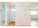 Inviting foyer with hardwood floors and a decorative partition, showcasing natural light at 6600 E 4Th Ave, Denver, CO 80220