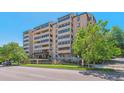 Exterior building shot showing facade, balconies, greenery, and attractive landscaping at 7420 E Quincy Ave # 304, Denver, CO 80237