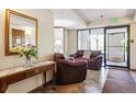 Lobby with comfortable seating, floral arrangement, and tiled floors at 7420 E Quincy Ave # 304, Denver, CO 80237