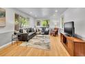 Bright living room with hardwood floors, neutral decor, and plenty of natural light from large windows, creating a cozy space at 755 S Milwaukee St, Denver, CO 80209
