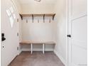 Bright entryway with built-in bench and storage shelf, next to a tiled floor at 2910 Clermont St, Denver, CO 80207
