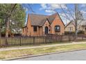 A beautiful brick home with a well-kept lawn and classic design elements at 2910 Clermont St, Denver, CO 80207