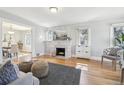 Living room featuring hardwood floors, a decorative fireplace, and view to dining area at 1462 Eudora St, Denver, CO 80220