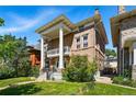 Brick home with prominent columns, a second-story balcony, and well-maintained landscaping at 1438 N Franklin St # 100, Denver, CO 80218