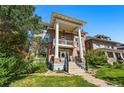Beautiful brick home featuring prominent columns, a second-story balcony, and a green lawn at 1438 N Franklin St # 100, Denver, CO 80218